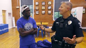 Police Officer Matt Yoder speaking to Corry Dawkins in Charlotte, Virginia