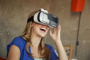 Woman laughing while using virtual reality glasses