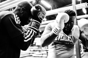 Black and white photo of two boxers practicing defensive poses