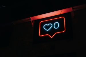Red neon sign of a heart and a zero in a text bubble