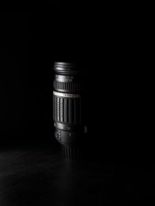 A tamaron camera lens with a black background
